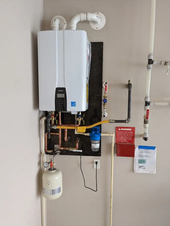 Professional plumber installing copper piping in a Belleville home